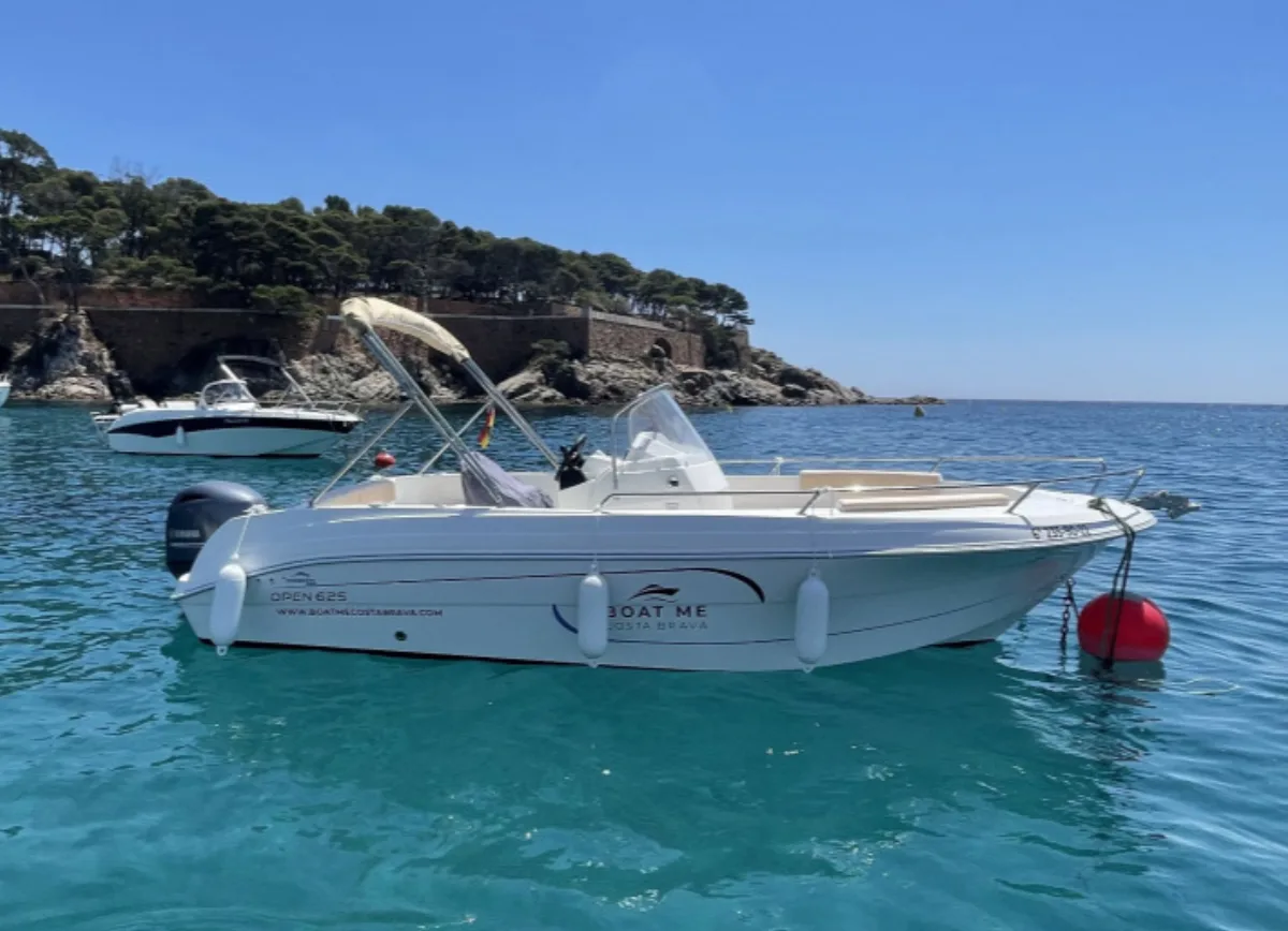 Licensed boat navigating along the Costa Brava coastline
